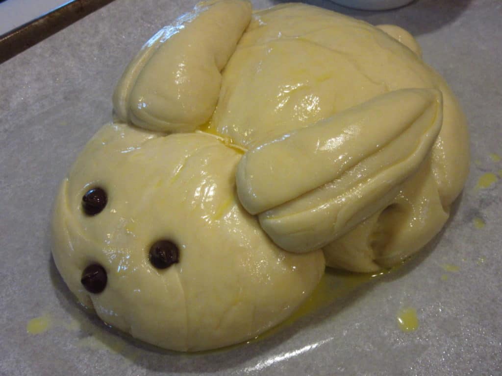 Dough bunny covered in egg wash.