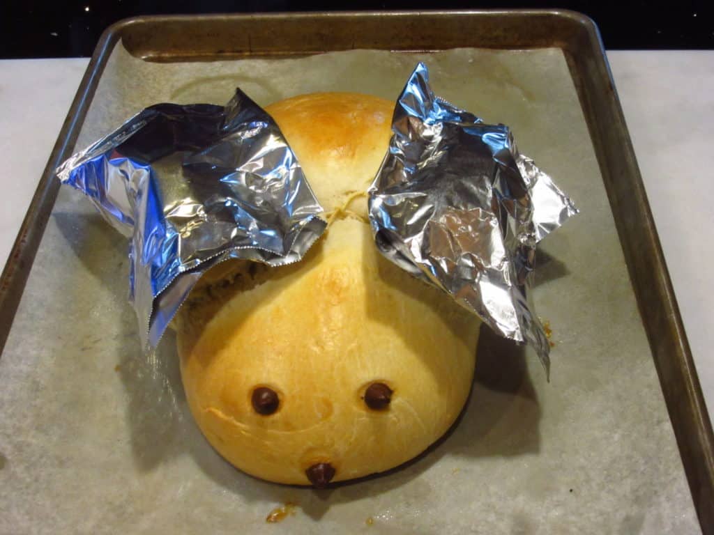 Partially baked bunny bread with foil over his ears.
