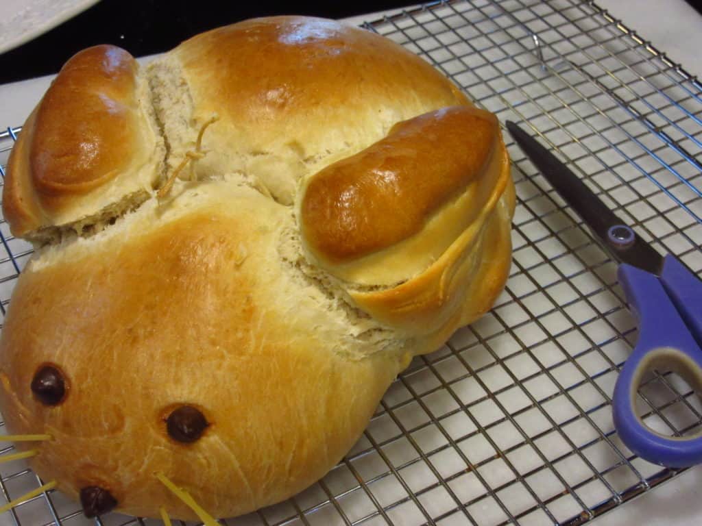 Golden baked bunny bread on a cooling rack.