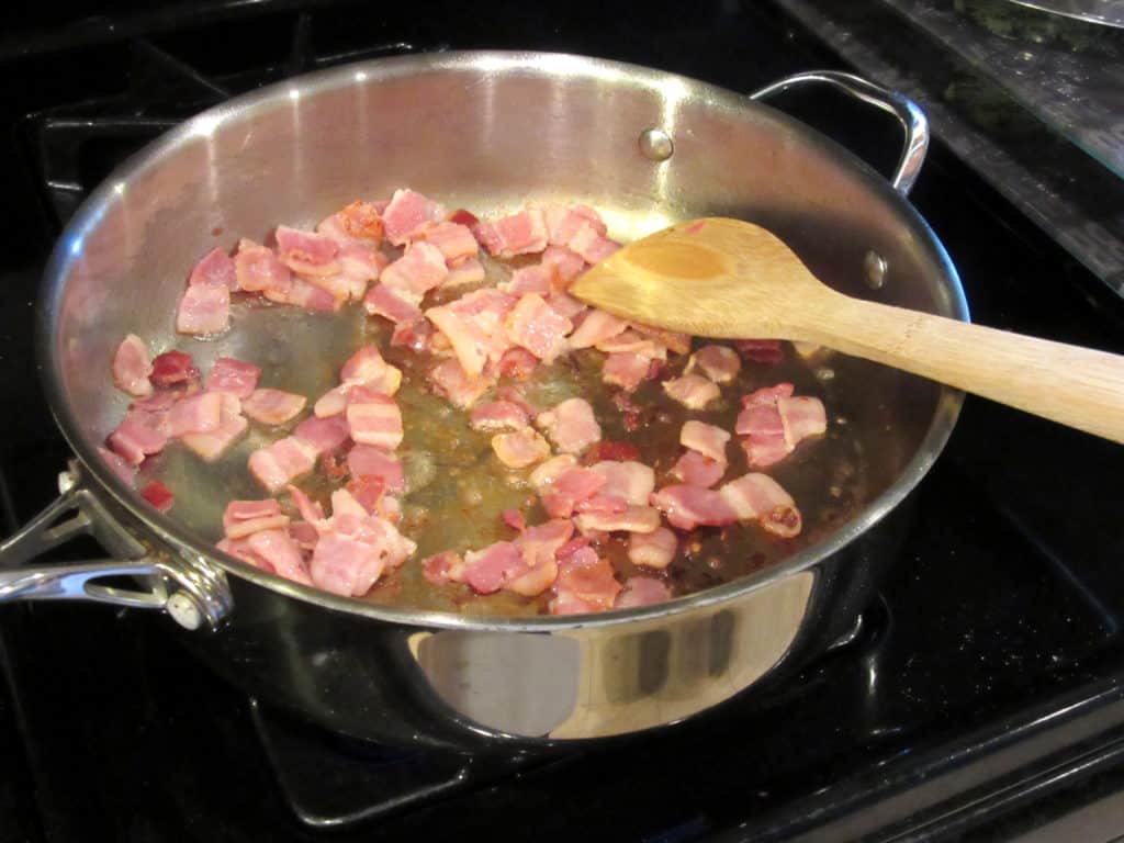 Cut bacon in a skillet for browning.