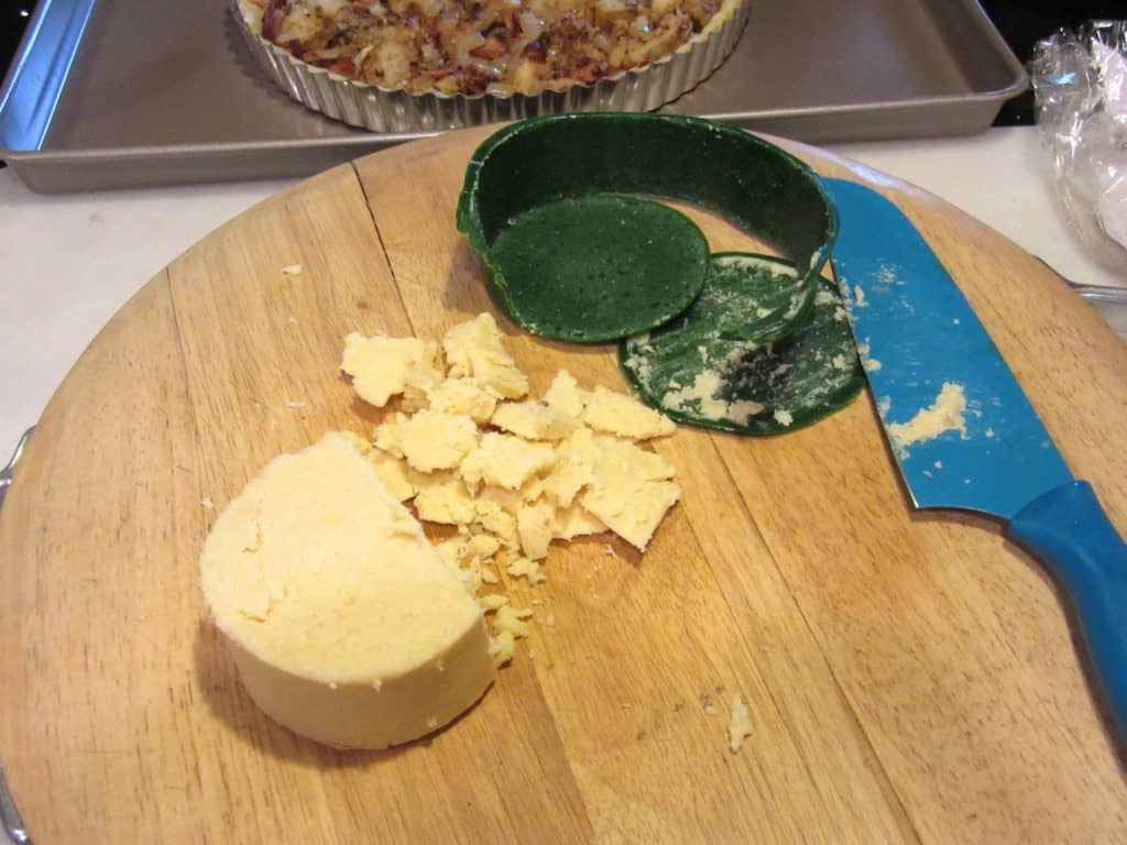 Chopped Dubliner cheese on a cutting board.