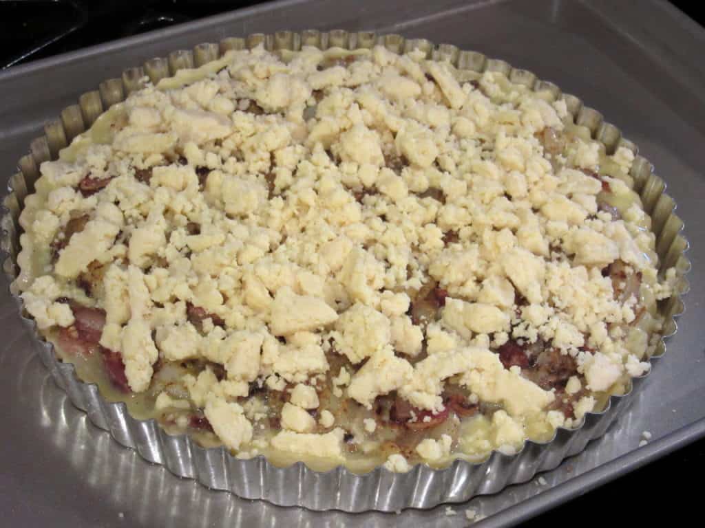 Dubliner cheese over the top of an Irish cheese and potato tart before baking.