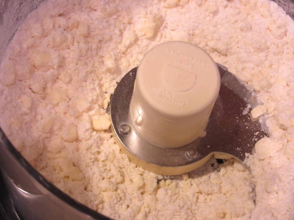Flour and processed butter in a food processor.