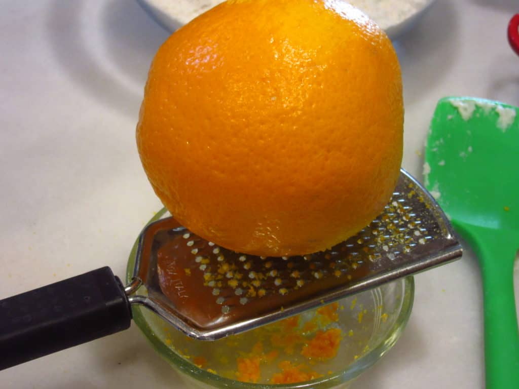 An orange on a grater.