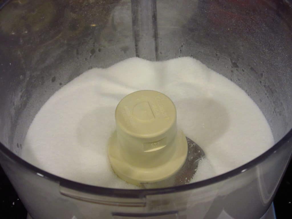 Granulated sugar in a food processor for making castor sugar.