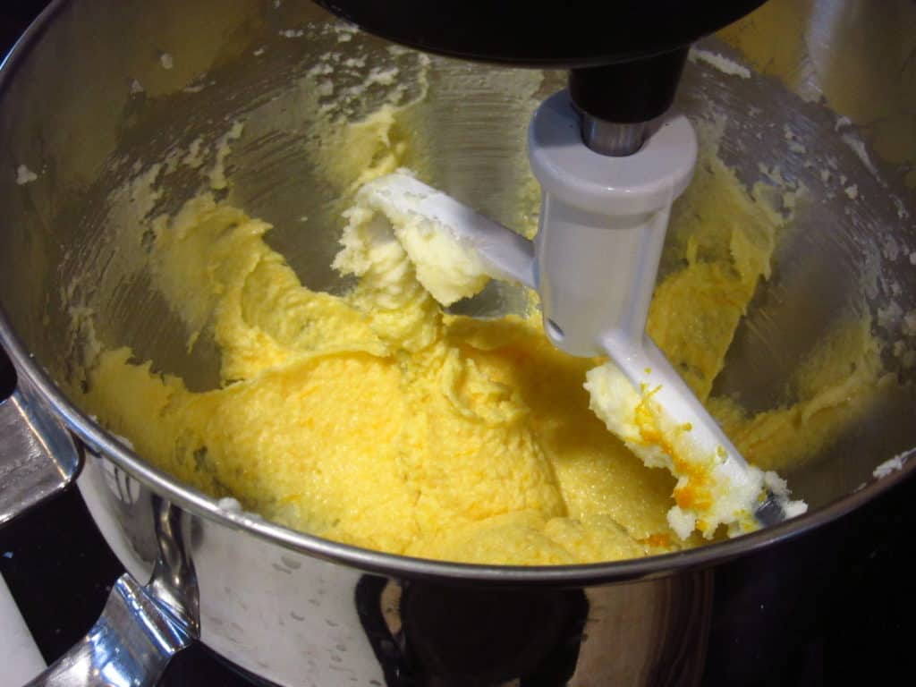 A butter mixture in a bowl with the paddle attachment.