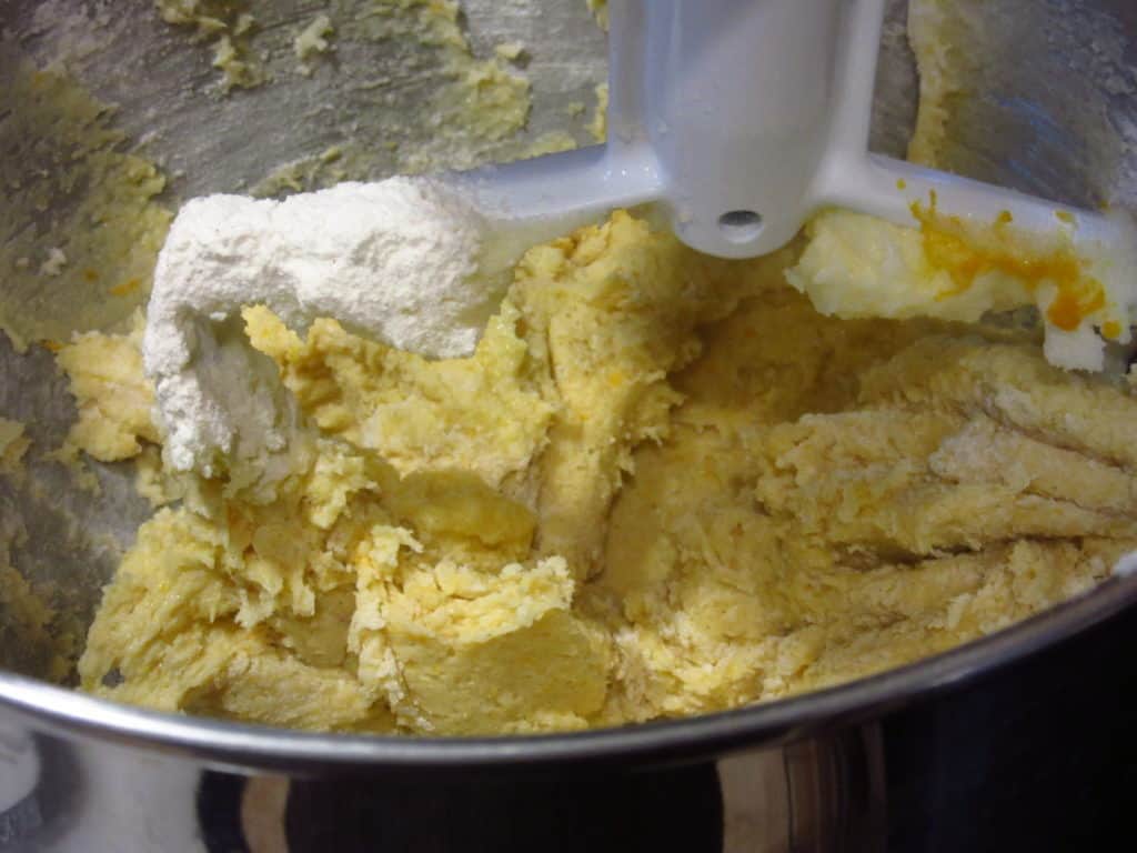 A cookie batter in a stand mixer with the paddle attachment.