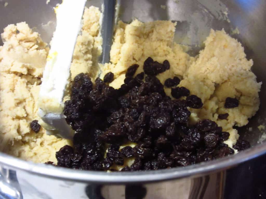 Currants in the bowl with a cookie dough.