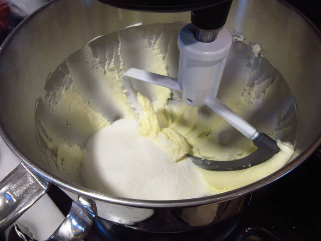 Creamed butter in a bowl with castor sugar.