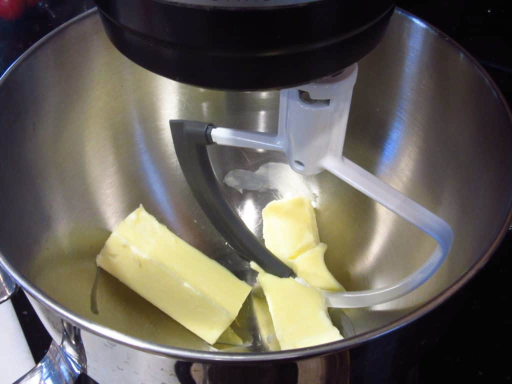 Butter in a stand mixer with the paddle attachment.