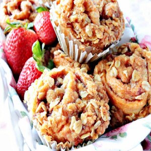Strawberry Crescent Muffins in a basket with fresh strawberries.