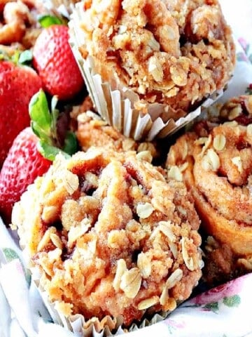 Strawberry Crescent Muffins in a basket with fresh strawberries.