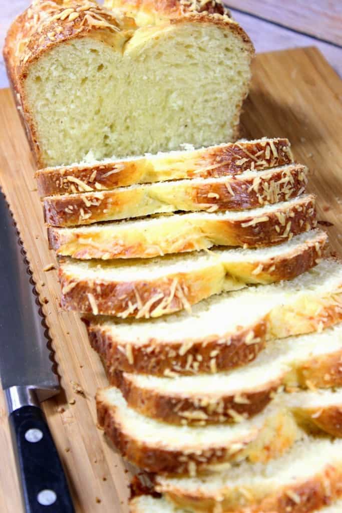 Vertical image of a sliced loaf of Italian Easter cheese bread