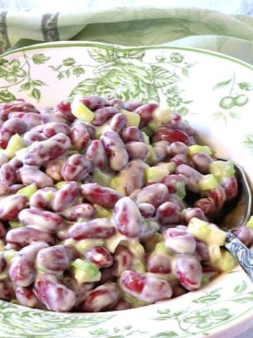 A bowl filled with old-fashioned red bean salad with a serving spoon