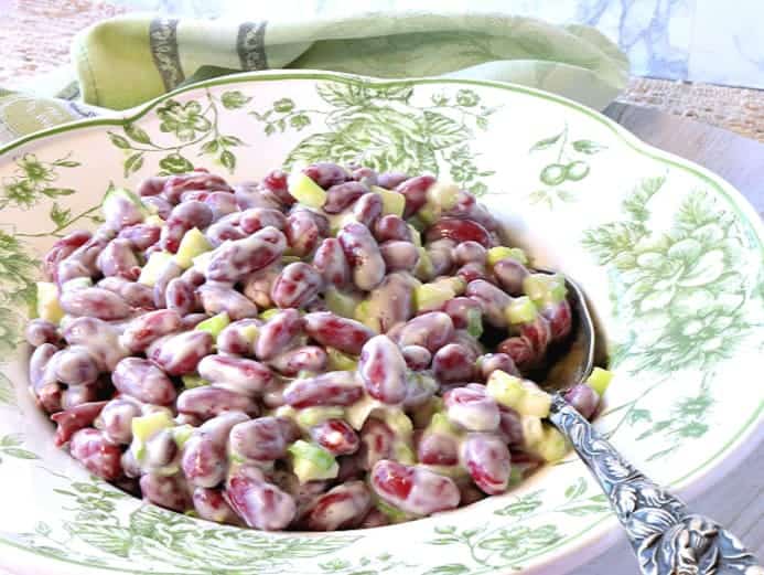 A bowl filled with old-fashioned red bean salad with a serving spoon