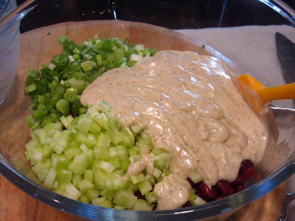 The ingredients for an Old-Fashioned Red Bean Salad in a glass bowl before mixing.