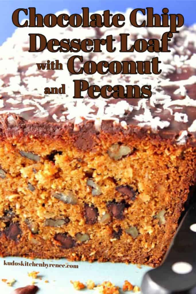 A vertical closeup of the inside of a chocolate chip dessert loaf with coconut and pecans.