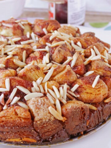 A round Raspberry Spice Monkey Bread on a square white plate.