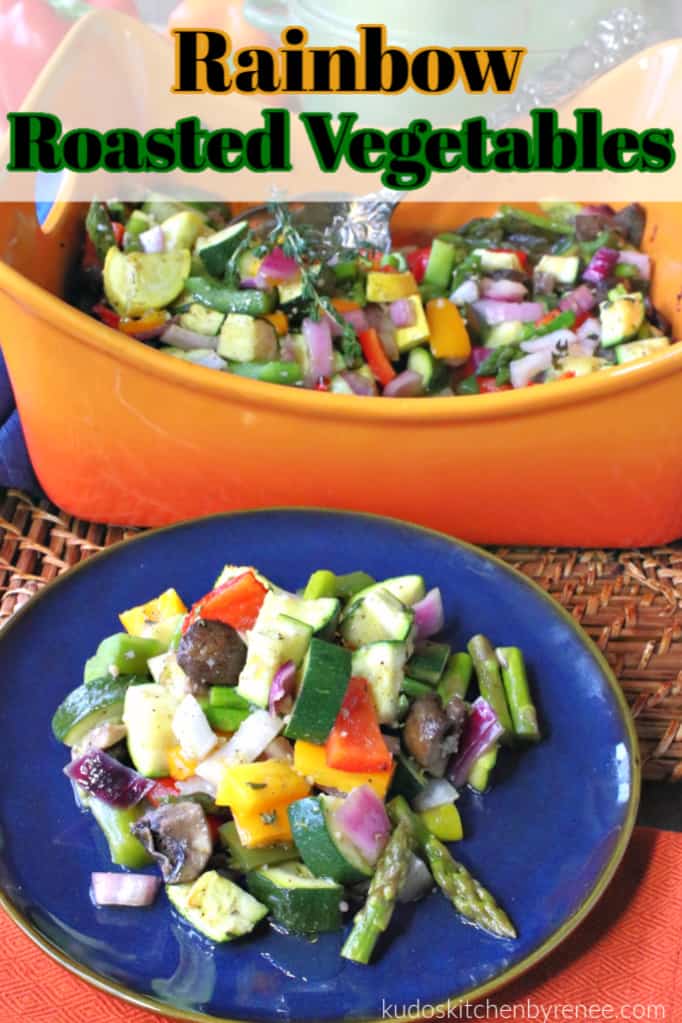 A round blue plate with roasted summer vegetable medley along with an orange casserole dish in the background.
