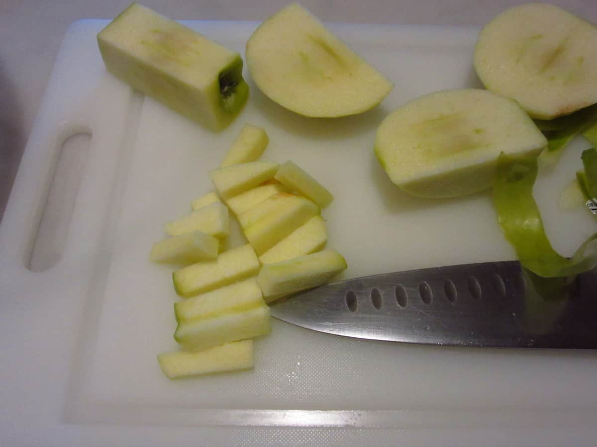 Apples being diced to make a pie filling.