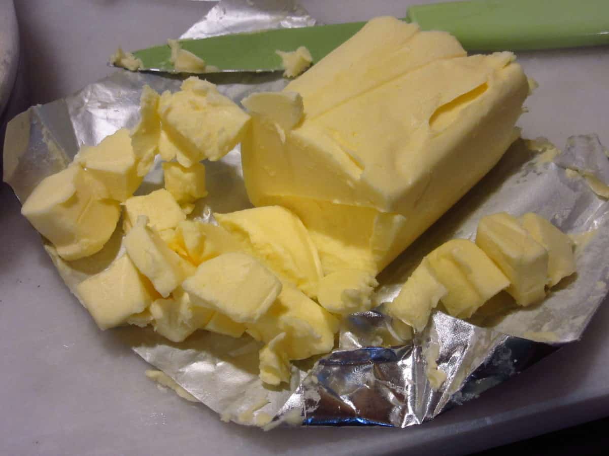 Cut up butter on a countertop.