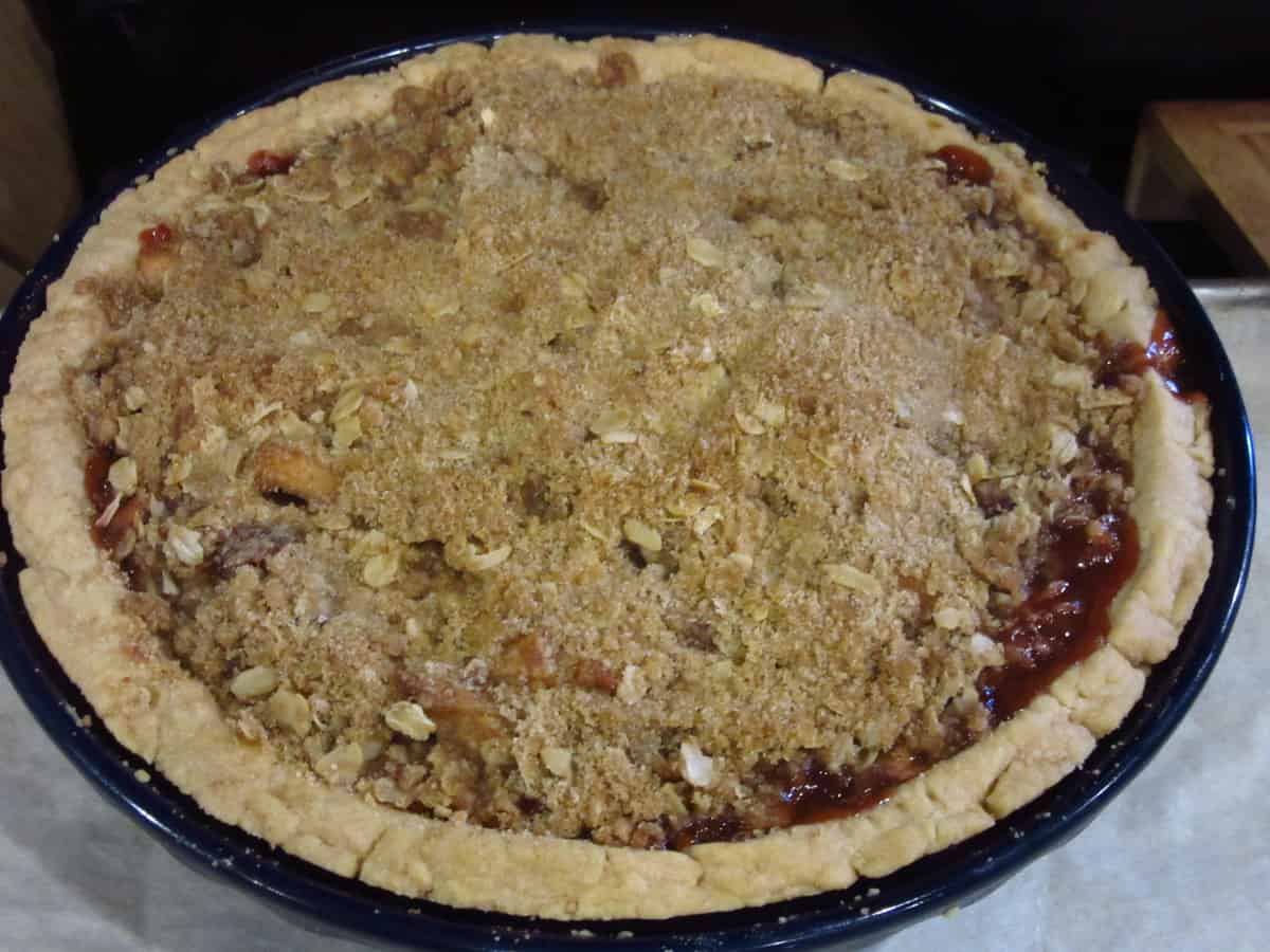 A baked Strawberry Apple Streusel Pie on a baking sheet.