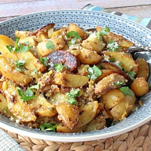 A blue bowl filled with Hot Roasted Potato Salad.