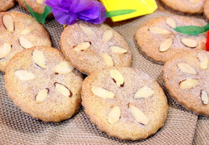 Closeup photo of a few sand dollar cookies on a sand colored napkin.