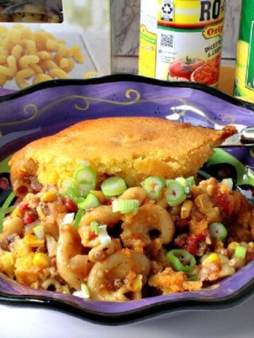 A large serving of Chili Mac with a Cornbread Crust in a purple bowl.