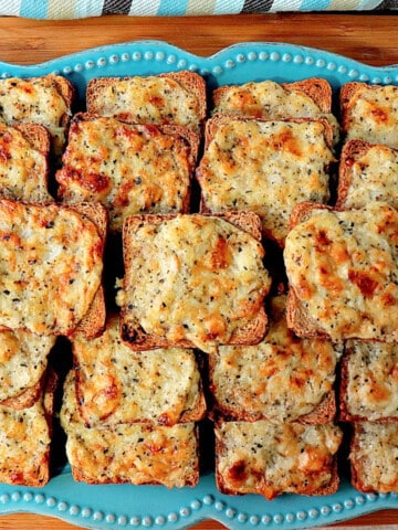 An overhead photo of Parmesan Onion Appetizer Squares on a blue plate.