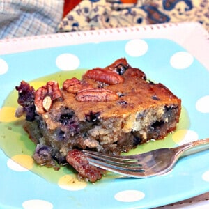 A slice of Sausage Blueberry Breakfast Cake on a blue and white polka dot plate.