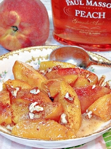 A serving of Peaches Foster in a bowl with a spoon.
