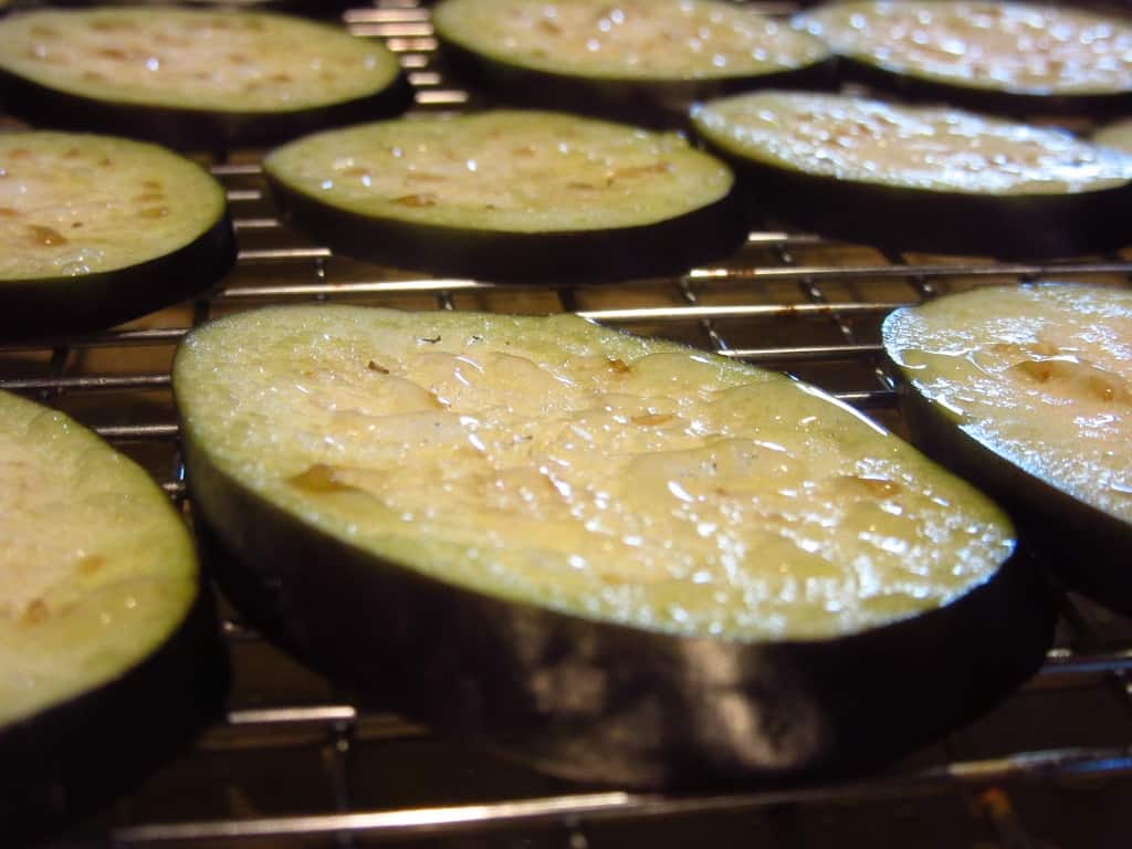 Droplets of water on an eggplant slice.