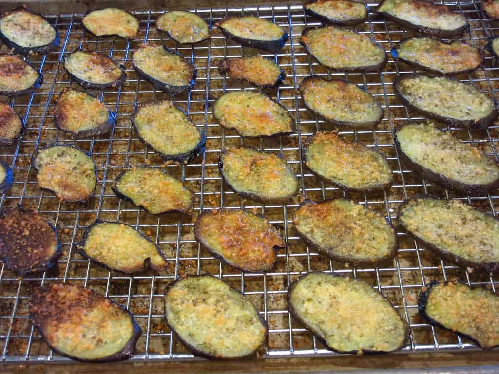 Baked slices of eggplant topped with golden brown cheese after baking.
