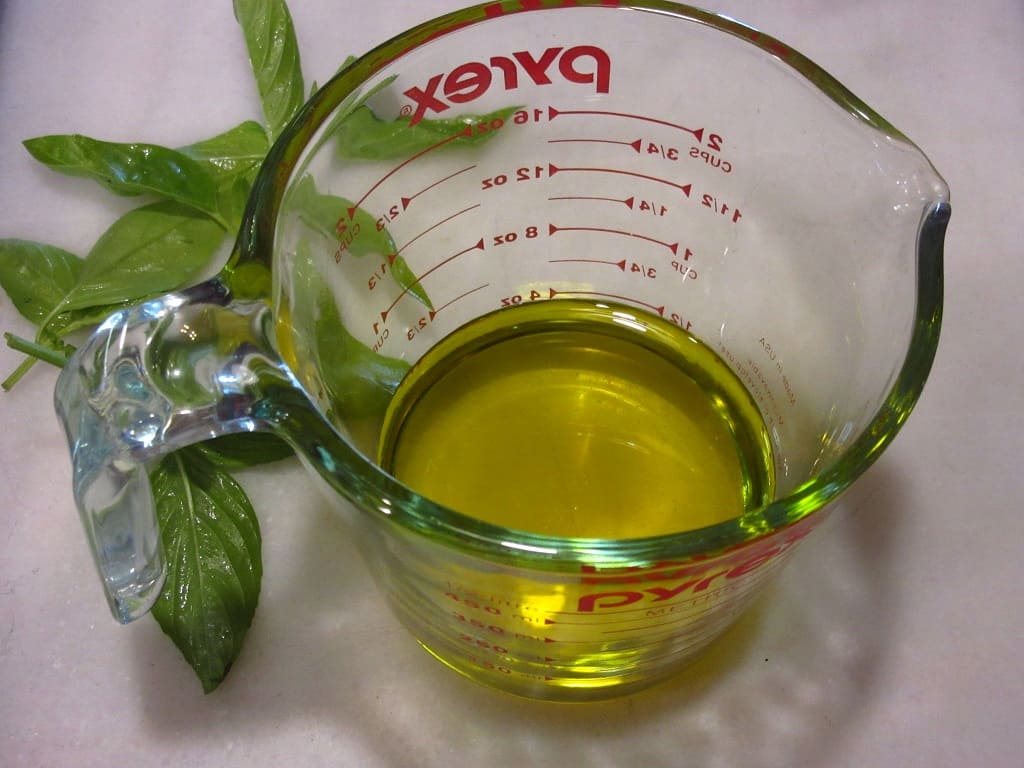 Olive oil in a measuring cup.