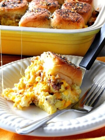 A Scrambled Egg Breakfast Slider on a white plate with a fork.