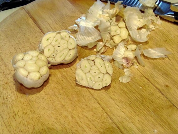 Garlic bulbs being prepared for roasting.