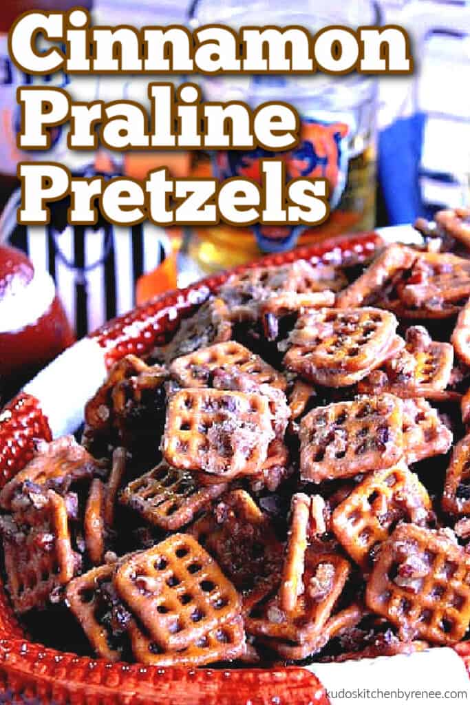 A vertical closeup image of a football bowl filled with cinnamon praline pretzels and a title text overlay graphic.