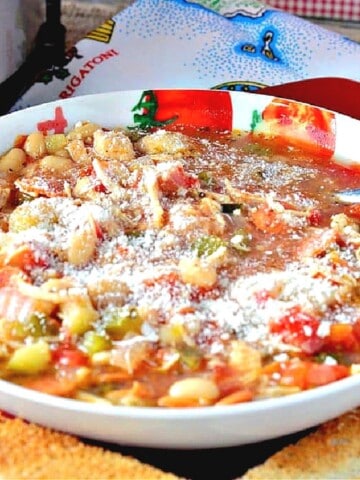 A serving bowl filled with colorful Italian Pepperoni Soup.