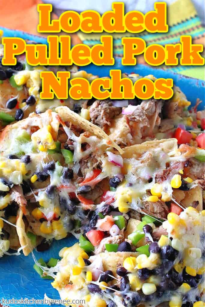 A colorful vertical closeup of Loaded Pulled Pork Nachos with green pepper, cheese, tomato, and corn along with a title text overlay graphic.