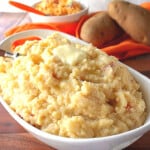 A white bowl filled with Pimento Cheese Mashed Potatoes.