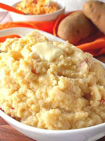 A white bowl filled with Pimento Cheese Mashed Potatoes.