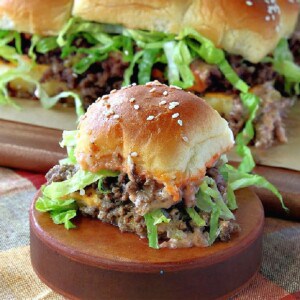 A Big Mac Slider on a wooden circle with more sliders in the background.