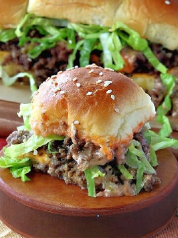 A Big Mac Slider on a wooden circle with more sliders in the background.