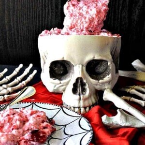 A skull filled with Brain Food Jello Salad and a red napkin.