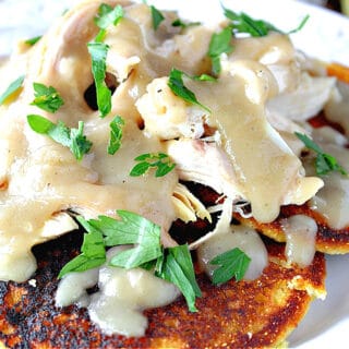 Corn cakes topped with chicken and gravy.