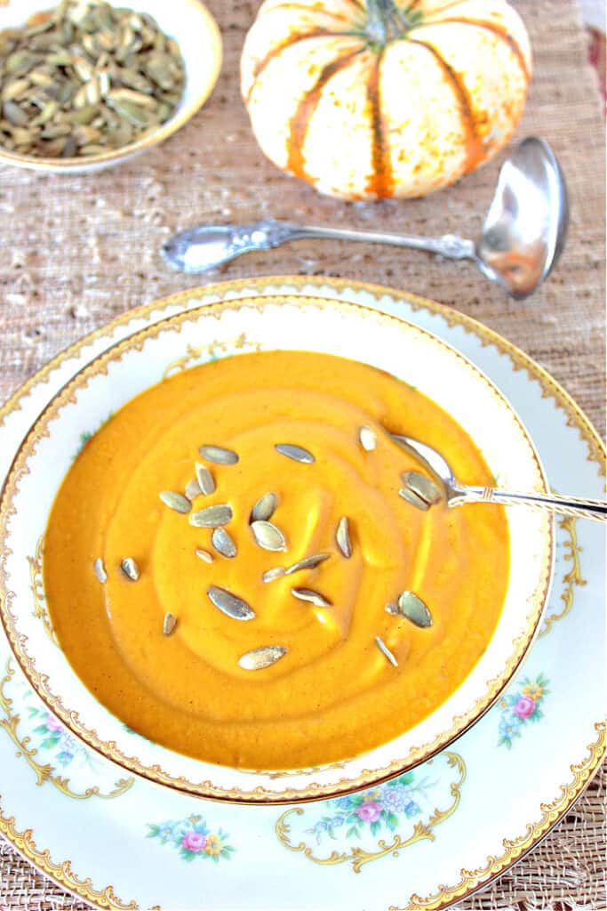 Roasted butternut squash in a pretty bowl with a spoon.