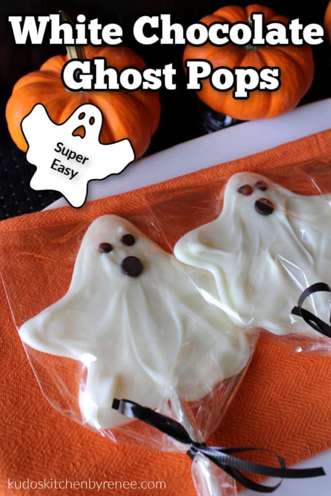 A closeup vertical photo of two white chocolate ghost pops on an orange napkin with pumpkins and a title text overlay graphic