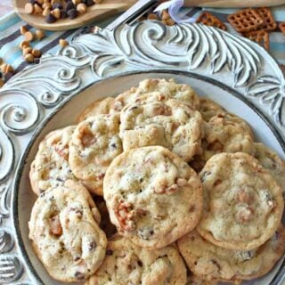 A vertical overhead image of a plate of Take 5 Cookies with pretzels and chocolate chips.
