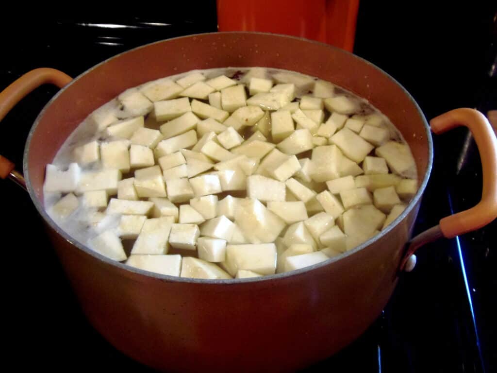 Celery root and potatoes in a pot of water.